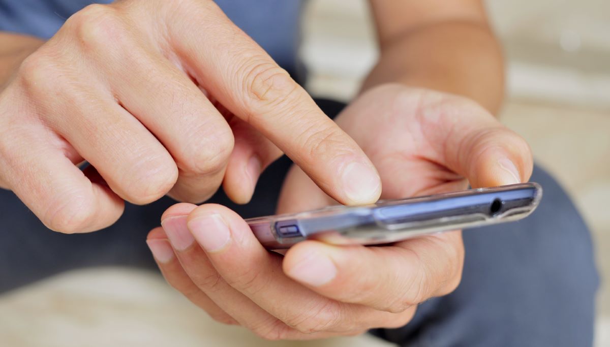 Man using smartphone closeup