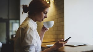 Restaurant employee looking at her mobile phone